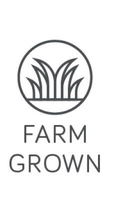 An icon displaying graphic grass inside a circle, labeled: FARM GROWN to indicate that Farm Fueled Nutrition's Superfueled Greens powder is all farm grown ingredients.